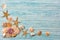 Summer sea background - shells, star on a wooden blue background