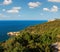 Summer sea perched Peschici town and cape Trabucco di Monte Pucci view, Gargano peninsula in Puglia, Italy