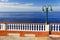 Summer seafront with street lamp and vintage fence in Canico, Madeira.