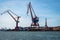 Summer seascape view of two large harbor cargo cranes against blue sky in Gothenburg Sweden.