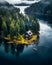 Summer Serenity: Lakeside Cabin Amidst Verdant Forests and Majestic Mountains