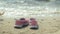 Summer shoes on the beach. in the background of a girl walking and dancing on the sand