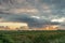 Summer shower with mammatus clouds in The Netherlands at sunset.