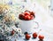 Summer simple still life. Sweet cherry in an iron mug and a bouquet of field tender flowers on the old window overlooking the gard