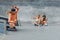 Summer. Skater Friends Skateboarding At Skatepark. Guy And Girls In Casual Outfit Having Fun Outdoor