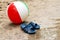 Summer slippers and Beach ball in sand