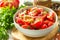 Summer snack or lunch. Fresh tomato salad with onions, herbs and olive oil on a white wooden table.