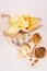 Summer snacks - nachos, croutons, chips, tortilla in rustic basket and paper corners on white wood background.