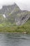 Summer snow on steep green side of Raftenfjord, Norway