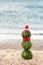 Summer snowman from watermelons in a red bow-tie and Santa`s hat.