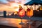 Summer soire two cocktails with blurred beach party, colorful sunset