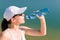 Summer sport fit woman drink water bottle