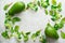 Summer and spring background of lettuce, spinach, chard and fresh avocado, on a light old gray concrete background. Selective