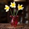 Summer still life with a bouquet. antique red glass vase with a bouquet of flowers in a luxury interior.