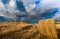 Summer storm looms over hay field in Tuscany, Italy