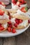 Summer strawberry cake or pastry with traditional shortcakes filled with whipped cream and marinated strawberries