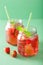 Summer strawberry drink with lime and mint in jars