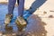 summer stroll kid in shoes in puddle.