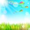 Summer sunny landscape with green grass and colorful kites