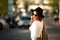 Summer sunny lifestyle fashion portrait of young stylish hipster woman walking on the street.