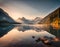 Summer sunrise on a beautiful lake with massive mountains