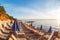 Summer sunrise on coast, Corfu island, Greece. Beach with Sunbeds and umbrellas with perfect views of the mainland