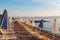 Summer sunrise on coast, Corfu island, Greece. Beach with Sunbeds and umbrellas with perfect views of the mainland