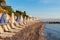 Summer sunrise on coast, Corfu island, Greece. Beach with Sunbeds and umbrellas with perfect views of the mainland
