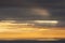 Summer sunrise with golden light and nimbostratus clouds over the Irish Sea. Dublin, Ireland