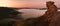 Summer sunrise in hills above river , colorful sky, colorful sandstone rocks.