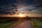 Summer sunrise over Dutch windmill on farmland