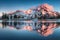 Summer Sunrise South Sister mountains in central Oregon near Bend are reflected in Green Lakes. Mountains in the cascade Range