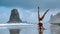 Summer sunrise yoga session on beautiful Playa de La Tejita beach with view on atlantic ocean and Punta Roja rock -