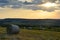 Summer Sunset over hay bales on the farms and hills of upstate New York