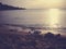 Summer sunset on the sandy beach; faded, filtered, vintage style