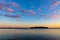 Summer sunset view of Jezioro Selmet Wielki lake landscape with wooded island in Sedki village in Masuria region of Poland