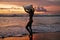 Summer. Surfer girl silhouette with surf board on sunset beach