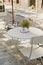 Summer table in a cafe on the summer terrace. White wooden table