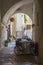 Summer terrace cafe in a narrow arched passageway of Polignano a Mare, Italy.