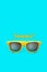 Summer! text and yellow sunglasses in intense cyan blue background. Minimal image concept for ready for summer