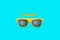 Summer! text and yellow sunglasses in intense cyan blue large negative space background. Minimal image concept for ready for summe