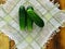 Summer is the time of harvesting vegetables and fruits. Fresh cucumbers are composed of a small slide on a tissue napkin, on a tab