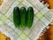 Summer is the time of harvesting vegetables and fruits. Fresh cucumbers are composed of a small slide on a tissue napkin, on a tab