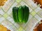 Summer is the time of harvesting vegetables and fruits. Fresh cucumbers are composed of a small slide on a tissue napkin, on a tab