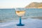 Summer time in Provence, drinking of cold gris rose wine on sandy beach and blue sea near Toulon, Var department, France