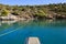 Summer time view from yacht gangway on the small beach of Love bay Poros island Greece.