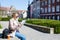 Summer and travel concept - woman in sunglasses with map, backpack and camera in old town of Tallinn, Estonia