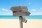 summer travel destinations options. Direction road sign with wooden arrows on beach and sea