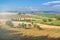 Summer Tuscan landscape, green field and blue sky