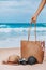 Summer vacation background concept. Hand of a woman carrying a wooden bag with sunglass on the summer beach Equipped with a camera